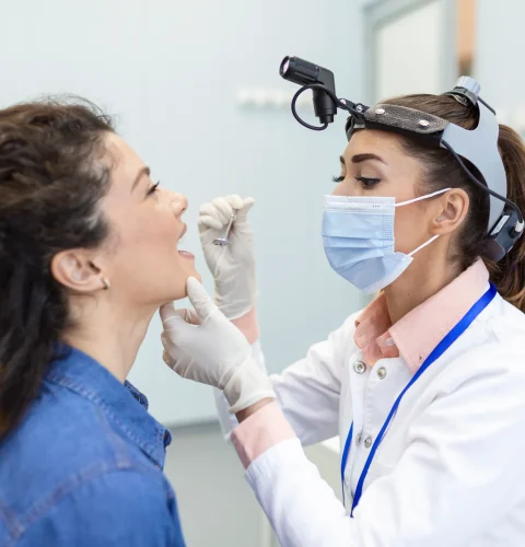 female-patient-opening-her-mouth-doctor-look-her-throat-otolaryngologist-examines-sore-throat-patient